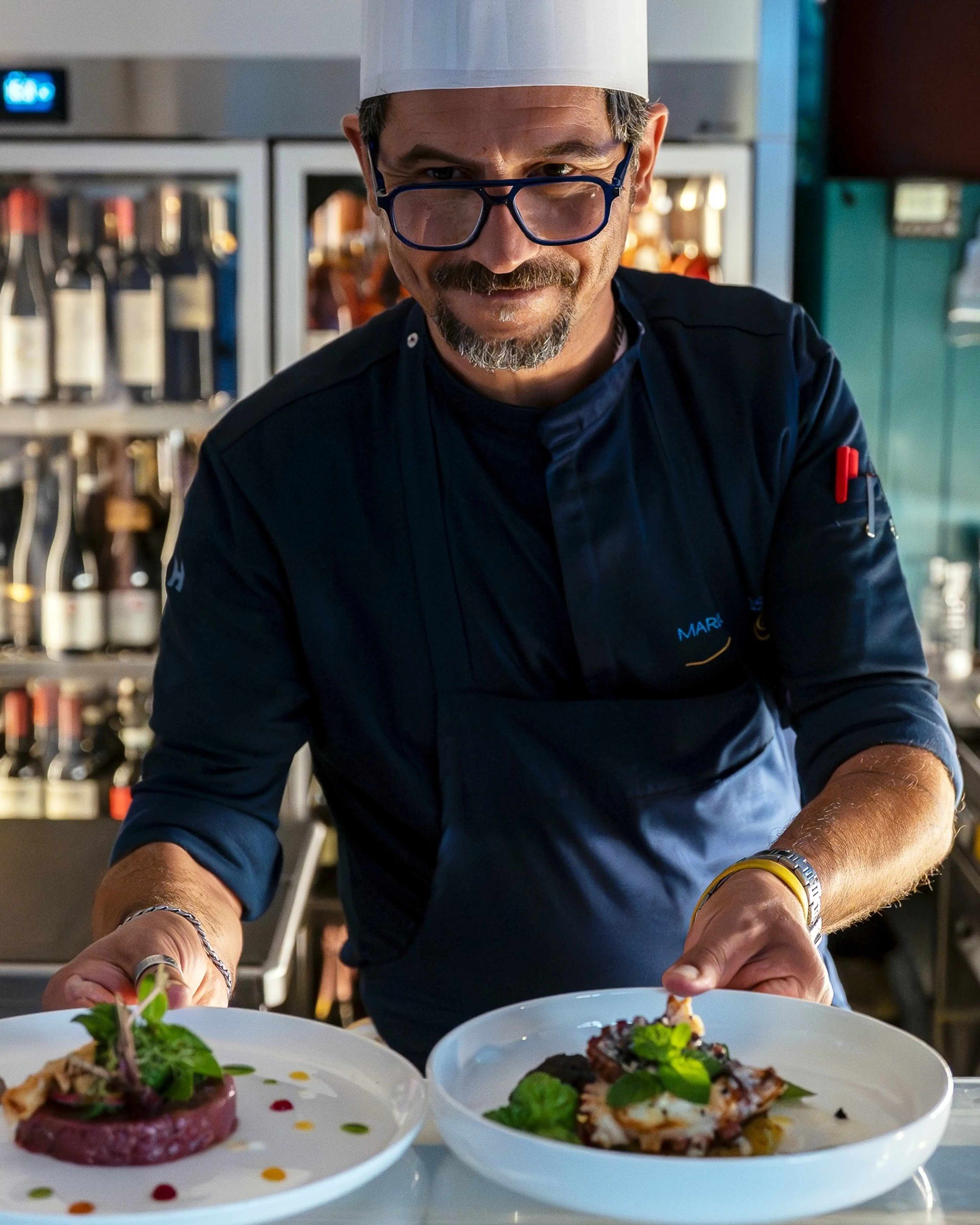 Chef Marco Russo presenting two signature dishes