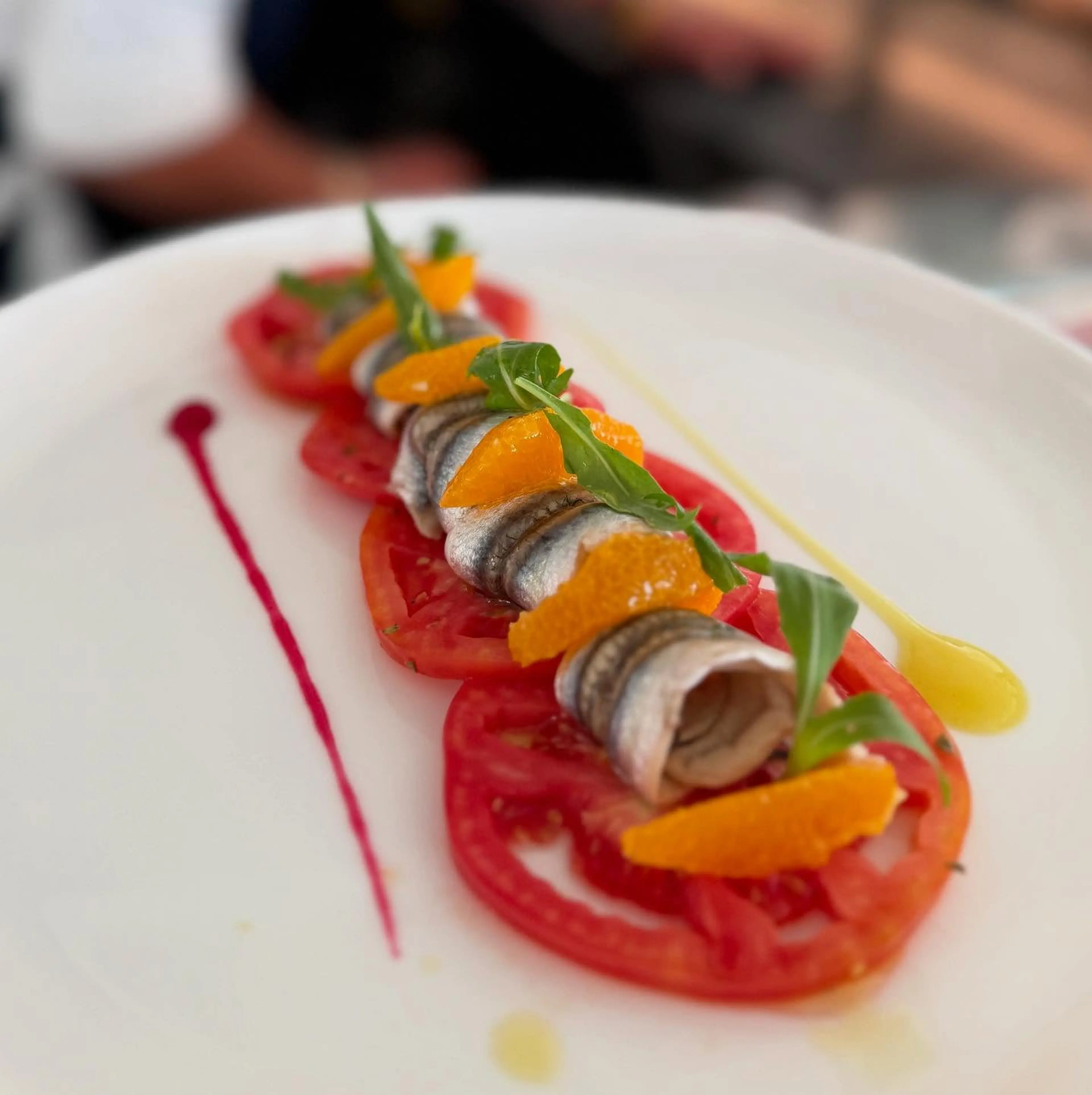 Marinated anchovies with tomato and orange