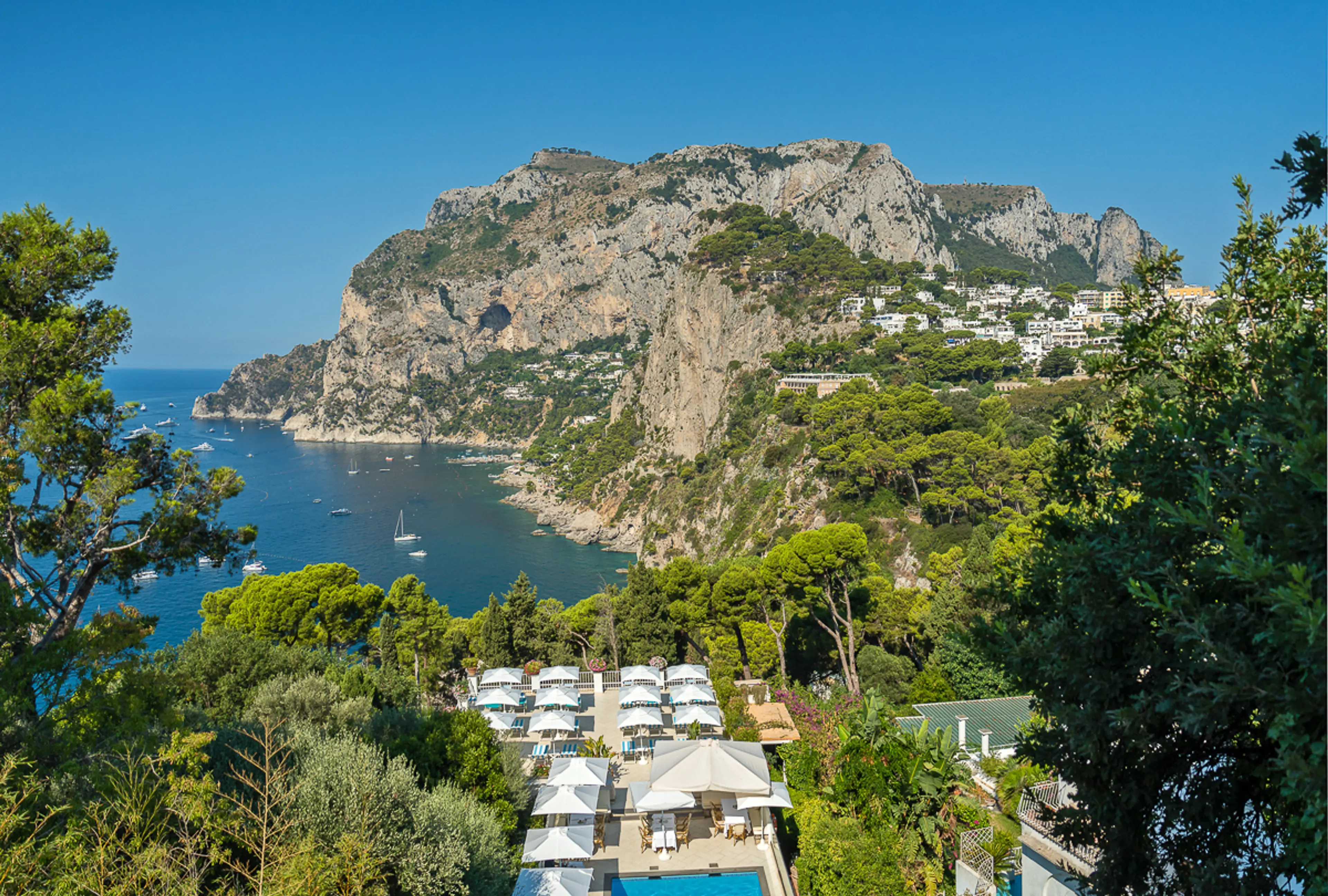 Hotel pool framed by the Capri cliffs