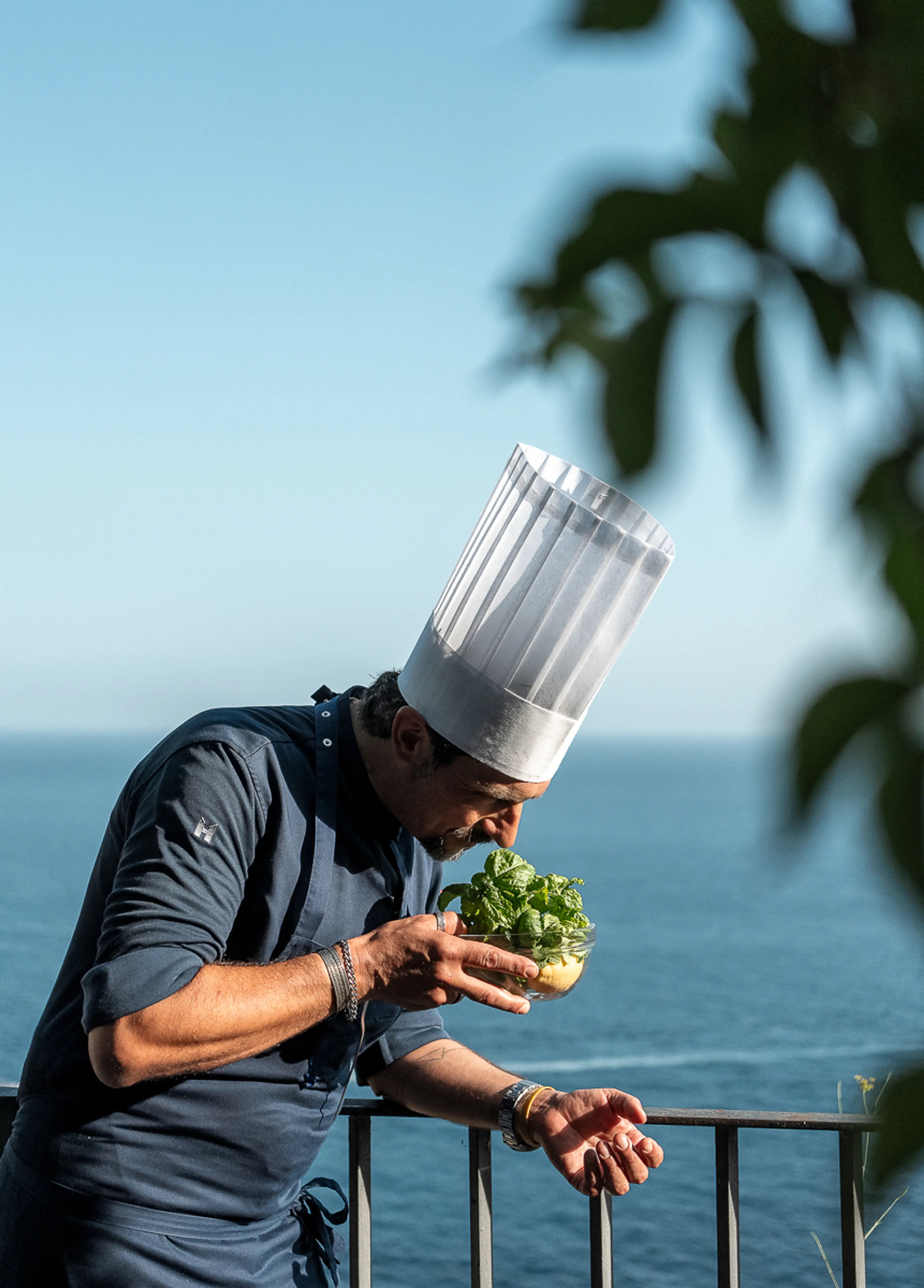 Chef Marco Russo inspecting fresh herbs