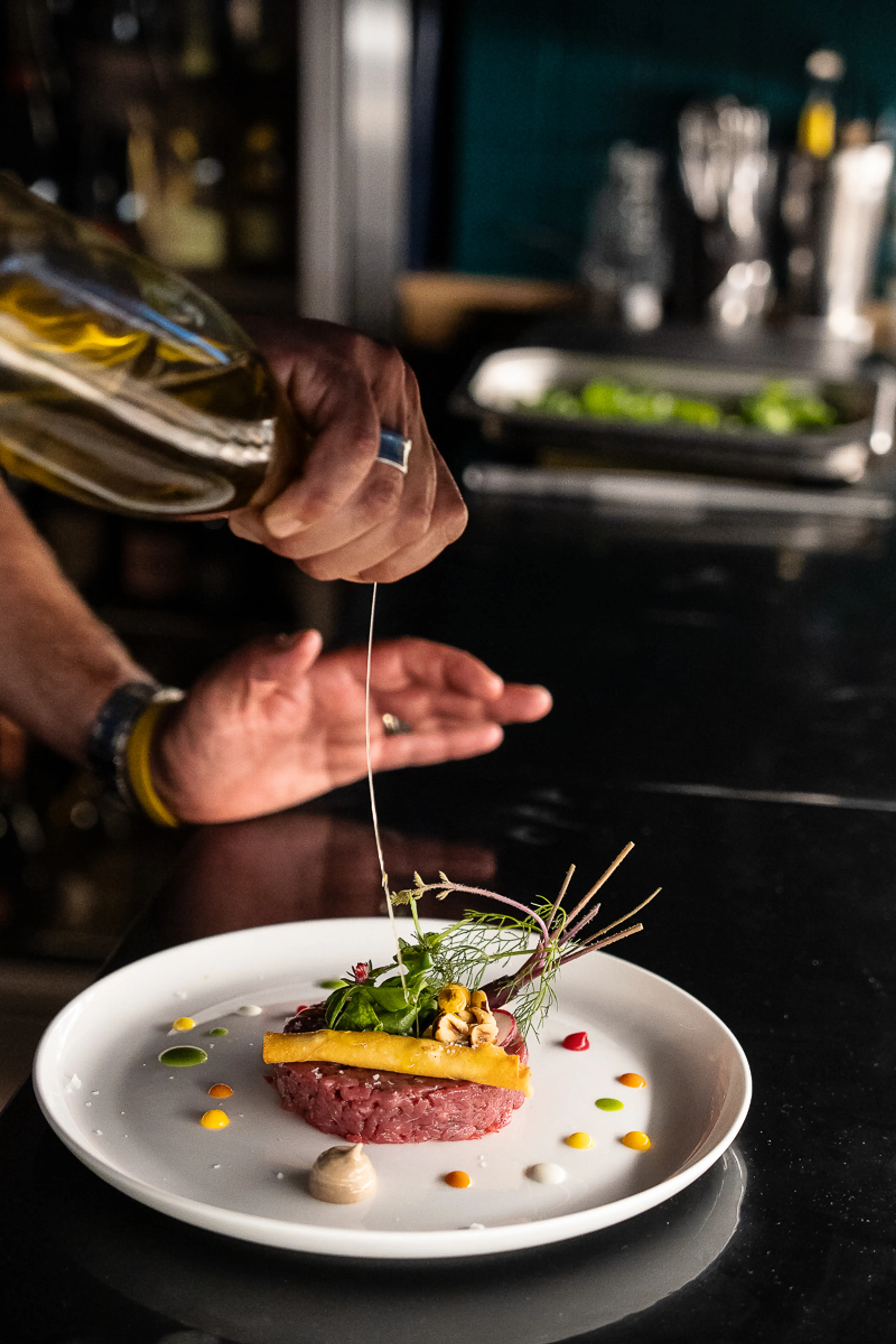 Chef Marco Russo finishing a beef tartare