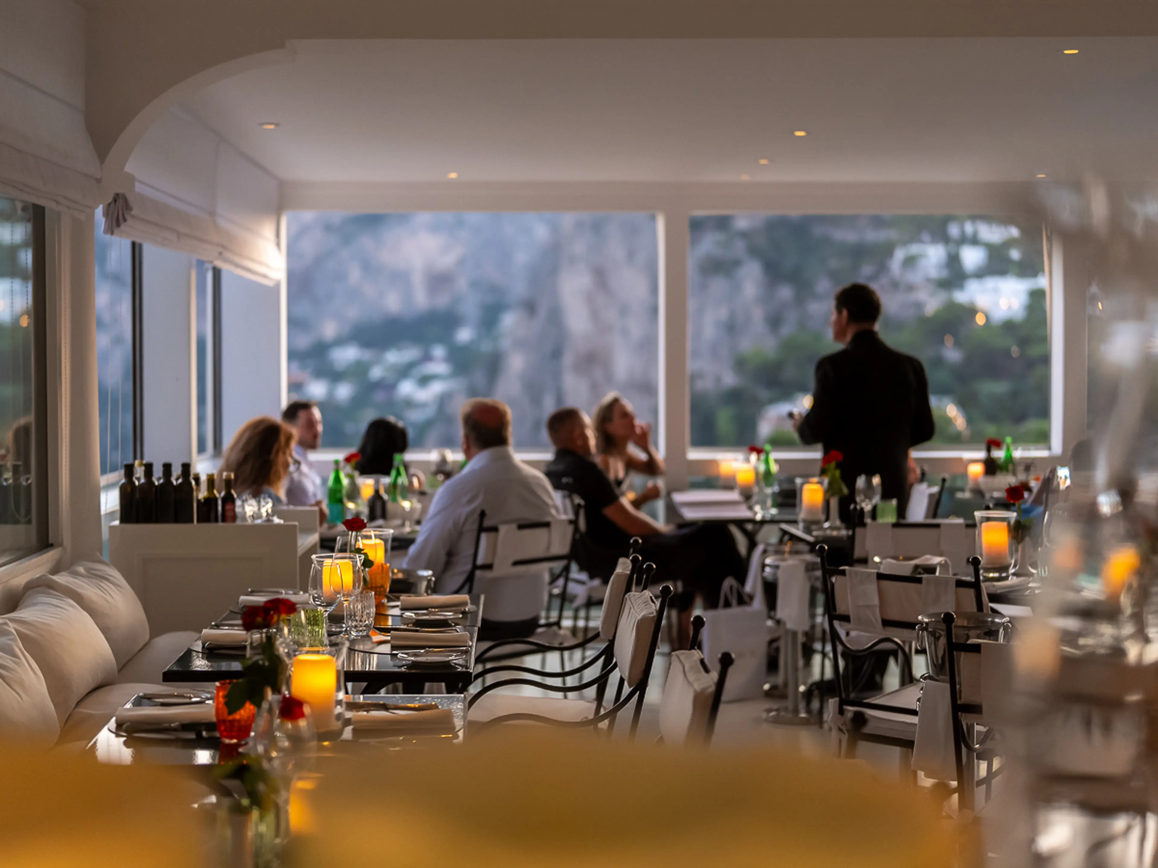 L'Agave dining room at dusk with sea view
